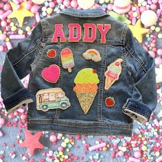 a denim jacket with patches on it that says addy and has ice cream, strawberry shortcakes, an ice cream sundae