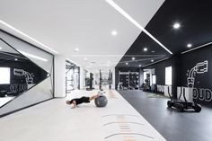 a man is doing push ups on an exercise ball in the middle of a gym