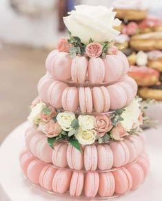 there is a cake made out of donuts and flowers on top of each other