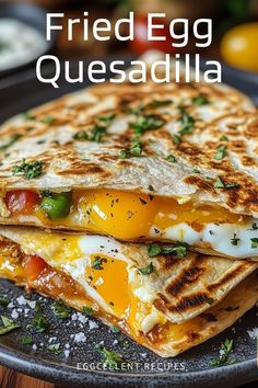 two quesadillas stacked on top of each other with the words fried egg quesadilla