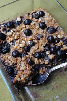 a glass dish filled with blueberries and granola