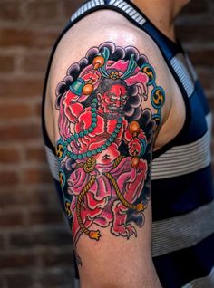 a man with a colorful tattoo on his arm