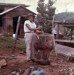 a man standing next to a tree stump