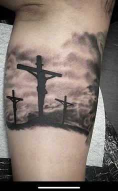 a tattoo with three crosses on it