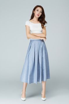 "Spring has sprung in this blue midi skirt from Xiaolizi. The linen skirt built in a high-rise, A-line silhouette with pleating throughout. The summer circle skirt topped with a banded waist + two seam pockets. DETAIL * 50% linen, 50% cotton * No lining * Seam pocket * Back zipper closure * Below Knee Length * Pleated Skirt * Perfect for summer, spring * Wash by hand or machine with cold water * The model is 163cm (5′4″) tall with a 80cm (31.5\") bust, 66cm (26\") waist. She is wearing the blue Pleated Flared Skirt For Summer, Pleated Waist Flared Summer Skirt, Summer Long Pleated Skirt With Pleated Hem, Long Pleated Skirt For Summer, Summer Pleated Long Skirt, Summer Midi-length Pleated Skirt, Blue Cotton Bottoms With Pleated Waist, Summer Full Skirt Bottoms With Pleated Waist, Spring Pleated Wide Leg Culottes