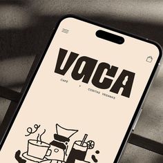 an iphone with the word voca on it next to a cup and saucer