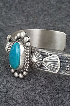 This Kingman turquoise and sterling silver bracelet was made by Navajo silversmith Michael Calladitto. The inside is signed MC and stamped Sterling.Size: 5 3/4" (will fit up to a 7 1/8" wrist)Gap: 1 3/8"Width: 1 1/8"Cuff Width: 1/2"Free shipping on all orders! We ship with USPS and always include tracking. All orders ship within a day of payment.Returns are accepted up to 30 days after you receive your order. Just send us a message. Our shop offers cash back or store credit. The item must be ret Artisan Turquoise Sterling Silver Bracelet, Adjustable Southwestern Sterling Silver Bracelet With Turquoise, Adjustable Turquoise Sterling Silver Bracelet In Southwestern Style, Adjustable Southwestern Turquoise Sterling Silver Bracelet, Stamped Turquoise Sterling Silver Bracelet, Stamped Sterling Silver Bracelet In Turquoise, Sterling Silver Turquoise Stamped Bracelet, Etched Turquoise Sterling Silver Jewelry, Southwestern Style Stamped Turquoise Bracelets