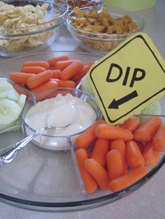 carrots, celery and onions are arranged on a glass platter with a dip sign