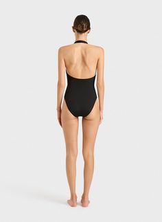 The Candice one piece in black is an elegant, feminine halterneck swimsuit that will never go out of style. The suit also works perfectly as a bodysuit worn under trousers or a skirt. A comfortable, wide, elasticated strap runs from under the shoulders and behind the neck. A scoop back reveals the shoulders. Self-lined in our ultra-soft Embodee™ fabric with high shaping power, Candice will become your go-to suit every summer. Luxury fabric sustainably made in Italy. Black One Piece Outfit, Australian Swimwear, Resort Wear Dresses, Summer Luxury, Halter Neck Swimsuit, Perfect Swimsuit, Swimwear Trends, Luxury Fabric, Elegant Feminine