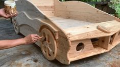 a person is making a wooden toy car out of plywood and wood planks