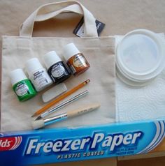 a bag with some pens, markers and other items in it sitting on a table