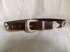 100% Genuine Leather  Australian Made  This is a 38mm (1 1/2") brown leather belt with a three piece Weston buckle set and big concord down the belt ( can be big and small conchos please ask) stitched in a brown  thread ( can be stitched in a silver thread, please ask) once you buy the belt just add a note to seller with the waist size you would like,  Waist size is from the buckle end of the leather to the middle hole then you will have three holes bigger and three holes smaller Classic Leather Belt Buckles For Rodeo, Brown Belt Buckle With Buckle Closure For Formal Occasions, Brown Formal Belt Buckle With Buckle Closure, Formal Brown Belt Buckle With Buckle Closure, Classic Brown Belt For Ranch, Formal Brown Belt Buckle With Closure, Classic Concho Belt Buckles For Rodeo, Leather Concho Belt Buckles For Formal Wear, Brown Leather Rodeo Belt