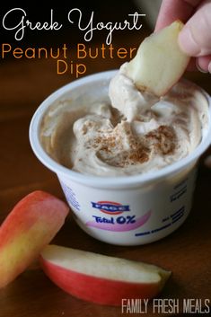 a person dipping an apple into a bowl of peanut butter dip with the words, greek yogurt