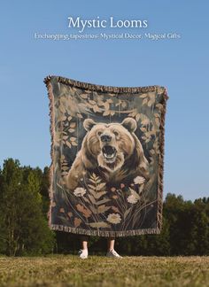 a person standing in front of a tapestry with a bear on it