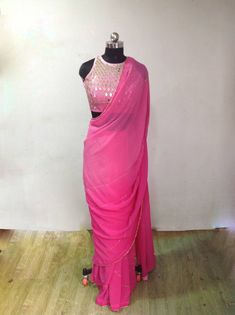 Graded pink ( light to dark) georgette embroidery saree with beautiful zardosi embroidery lines. Blouse is available as a seperate listing. The saree can be made in other colors as well Blouse: https://www.etsy.com/listing/957833251/custom-fit-graded-pink-mirror-work Festive Pink Pre-draped Saree With Mirror Work, Festive Pink Pre-draped Saree With Dori Work, Designer Pink Pre-draped Saree With Zari Work, Pink Party Wear Pre-draped Saree With Mirror Work, Pink Chinon Pre-draped Saree For Navratri, Pink Saree With Gota Work, Pink Chinon Sharara With Cutdana Detail, Pink Chanderi Pre-draped Saree For Reception, Pink Party Wear Choli With Cutdana