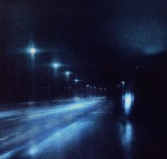 a blurry photo of an empty street at night