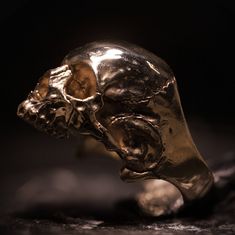 Our Bronze Halfjaw is a high-polished representation of an anatomically correct skull, of which the detail and accuracy is unparalleled. This piece is solid bronze and made to last centuries. In contrast to most other jewelry, wearing our skulljewelry will make it come to life even more. As weird as it may sound, due to scratches and dents, It will become more beautiful over time. Each piece is finished separately by hand to ensure perfect quality. *Attention! Due to the overwelming interest com Classic Engraved Skull Jewelry, Gold Skull-shaped Engraved Jewelry, Luxury Skull Ring As Gift, Gold Skull Shaped Collectible Ring, Gold Skull Ring Collectible, Gold Skull Collectible Jewelry, Gold Skull Jewelry Collectible, Gold Skull Jewelry For Collectors, Collectible Skull Jewelry In Lost Wax Casting