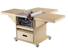 a workbench with a table sawing machine on it's side and drawers underneath