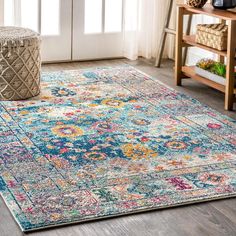 a large rug with an ornate design on the floor in front of a door and window