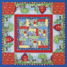 a blue quilt with red and green farm animals on it's sides, in the middle