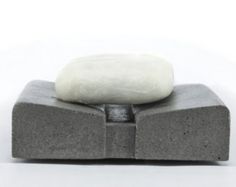 an object made out of concrete with a white substance on top