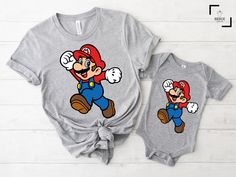 "Super Mario Shirt, Mario Shirt, Birthday Gift, Retro Game Shirt,Gift for Gamer,Video Game,Mario Party Shirt, Vintage Gamer Shirt Hello there! Welcome to our store SerixDesign, we are glad to see you here. The main purpose of our store is to make you happy. We see you as a friend, not just a customer. If you have any questions or would like to purchase a custom design, please contact us. We are sure you will like our designs. We will try our best to make you satisfied. HOW TO ORDER YOUR SHIRT? 1-) Please Check and Review All Photos. 2-) Choose your T-Shirt Size and T-Shirt Color from the drop-down menus. 3-) Choose your amount as much as you want. 4-) Click the ADD TO CART button. You can return or complete the checkout process to add more product colors for your family members. 5-) Please Character Print Crew Neck Top As Gift, Crew Neck Top With Character Print As Gift, Family Matching Crew Neck Shirt With Cartoon Print, Mario Shirts Birthday, Mario Birthday Tshirt, Mario Tshirt, Super Mario T Shirt Design, Super Mario Tshirt, Super Mario Shirt