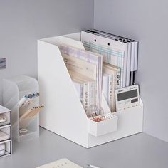 there is a white desk with many items in it