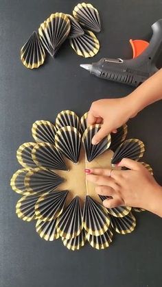 someone is cutting out some paper flowers with scissors