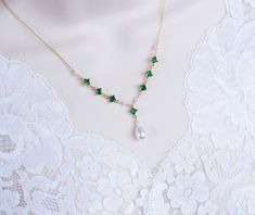 Vintage, Romantic Style Emerald Necklace, Wedding Pearl and Emerald CZ Bridal Choker, Emerald CZ Vintage Swarovski Pearl Necklace  Materials used: - White/Ivory Cream Swarovski pearls - cubic zirconia stones - gold plated over brass The necklace will arrive packaged ready for gift giving in a delicate white jewelry box with a silver ribbon. Matching earrings for this necklace:  Back to my shop http://www.etsy.com/shop/crinadesign73 Thank you for visiting my store! Delicate Green Necklace For Wedding, Delicate May Birthstone Necklace For Weddings, Delicate Wedding Necklace With May Birthstone, Elegant Wedding Necklace With May Birthstone, Elegant May Birthstone Necklace For Weddings, Elegant Wedding Necklace For May Birthstone, Swarovski Pearl Necklace, Bridal Choker, Silver Ribbon