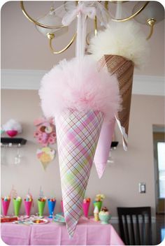 an ice cream cone decorated with pink feathers