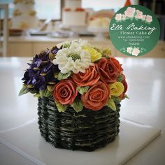 a basket filled with flowers sitting on top of a white counter next to a sign