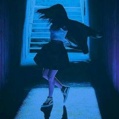 a girl in a dark room with an open door and her hair flying through the air