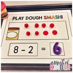 a printable play dough smash game with numbers and candy on the table next to it