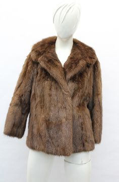 DESCRIPTION: BROWN MUSKRAT FUR JACKET!  THE COLLAR TYPE IS "NOTCH", IT CLOSES WITH HOOK & EYE CLOSURE AND HAS TWO SIDE POCKETS. THIS ITEM IS SCRAP: THE FUR IS DAMAGED BUT THE GOOD PART CAN BE USED FOR FUR ACCESSORY PROJECT! MEASUREMENTS:   SIZE: N/A LENGTH: 23"  SLEEVES: 25"; VERY SHORT LENGTH; MEASURED FROM THE SIDE OF THE NECK TO THE CUFF. b4462 Oliverfurs 9250 Parc Ave. #204, Montreal, Quebec, H2N 1Z2, Canada www.oliverfurswholesale.com oliver@oliverfurswholesale.com Toll free: 1-866-845-9997 Brown Fur Jacket, Raccoon Fur Coat, Fur Accessories, Sheepskin Jacket, Montreal Quebec, Brown Coat, Hook Eye, Men's Coats And Jackets, Fur Jacket