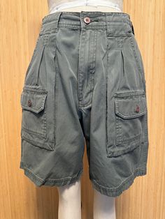 These great-looking vintage shorts feature multiple pockets front and back, a high rise and zip fly. No labels whatsoever.  Very good vintage condition. Feels like cotton or cotton blend.  Detailed Measurements: Waist - 28 inches  Hip - 39 inches  Rise - 12 inches  Inseam - 7.5 inches Military Style Cotton Cargo Shorts With Patch Pockets, Utility High-waisted Shorts With Patch Pockets, Utility Shorts With Patch Pockets, Utility Cargo Shorts With Patch Pockets, Vintage Cotton Bottoms With Multiple Pockets, Outdoor Bermuda Shorts With Pockets, Utility High-waisted Cargo Shorts With Patch Pockets, High-waisted Utility Cargo Shorts With Patch Pockets, High-waisted Cargo Shorts With Patch Pockets