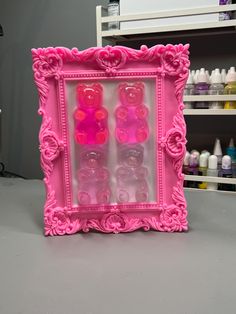 a pink frame with buttons in it sitting on a table