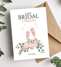 a card that says happy bridal shower with two champagne glasses and flowers on it