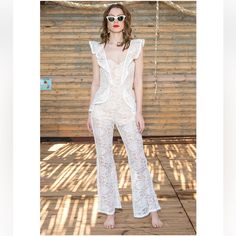 Gorgeous And Sexy Lace Jumpsuit. Nwt Brand Is Seven Wonders From Australia. Available For $120 At Our Store Chiccouturecloset.Com Crafted From Detailed Delicate Lace, Our Flattering Daisy Jumpsuit Will Make Sure All Eyes Are On You. Featuring High Waist With Slight Flared Pants, Frilled Detailing And Delicate Lace. It's The Perfect Jumpsuit For Special Balmy Nights (And Days). - Delicate Luxe Lace - Frilled Detailing Along Shoulder Straps - Boning In The Bodice - Exposed Zip At The Back Of The G Fitted White Jumpsuits And Rompers For Beachwear, White Fitted Jumpsuits And Rompers For Beach, White Fitted Jumpsuit For Beach, White One-piece Jumpsuit For Night Out, White Fitted Feminine Jumpsuits And Rompers, Feminine White Jumpsuits And Rompers For Beach, White Feminine Jumpsuits And Rompers For Party, Feminine White Jumpsuits And Rompers For Party, Feminine White Jumpsuit For The Beach