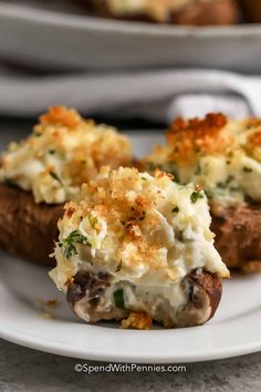 a white plate topped with meat covered in cheese