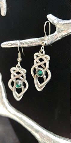 "Hand cast and hand finished out of lead-free Britannia Pewter. This pair of Celtic Knot earrings measures 1 1\\/4\" x 5\\/8\" and the earring post is surgical steel. Matching necklace is also available. I have more than one item in stock, if you require more, please contact me. History of Celtic Knots Celtic knots or Celtic interlace are ornamental patterns that first became associated with Celtic people in the early Celtic Church where they were used to decorate Bible. Monks used the Celtic kn Hand Cast Silver Dangle Earrings, Silver Hand Cast Dangle Earrings, Unique Hand Cast Dangle Jewelry, Adjustable Hand Cast Earrings As Gift, Symbolic Metal Jewelry With Matching Earrings, Hand Cast Silver Drop Earrings, Silver Hand Cast Drop Earrings, Unique Pewter Jewelry For Gifts, Silver Pewter Earrings As Gift