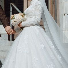 the bride and groom are walking down the stairs