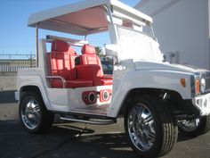 a white jeep with red seats parked in front of a building