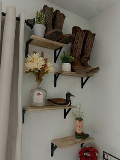 some shelves with boots and flowers on them