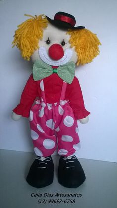 a stuffed toy clown wearing a red and white polka dot outfit