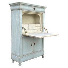 an old - fashioned kitchen cabinet with a stove top on casteors and wheels, painted in pale blue