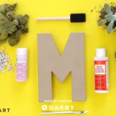 the letter m is made out of wood, glue, and other crafting supplies