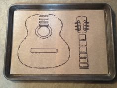 a guitar cut out on a piece of paper