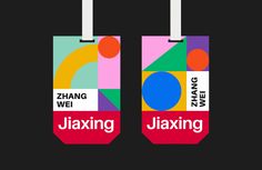 two luggage tags with the words juxting and zang on them, hanging from strings