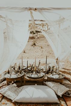 a table set up on the beach for dinner