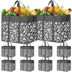 four shopping bags filled with different types of fruits and vegetables